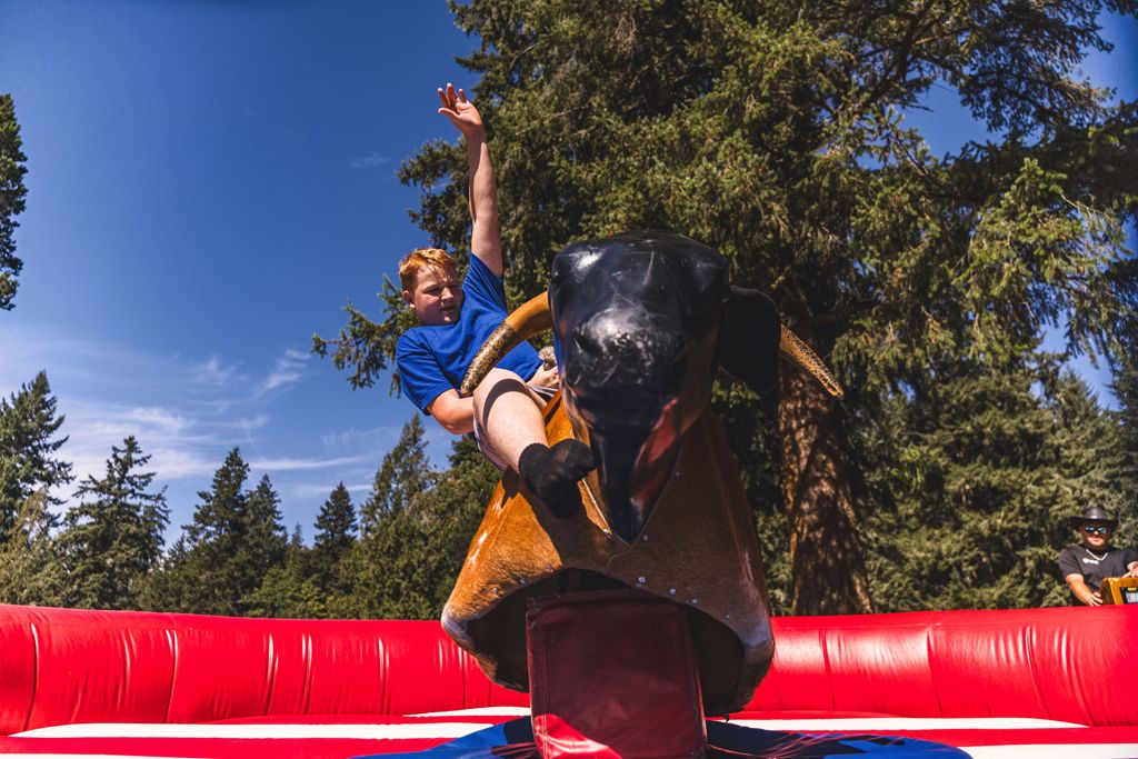 A rider on the mechanical bull at a past Cool August Nights