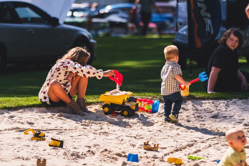 Kids playing in the sand pit at a past Cool August Nights
